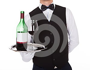 Waiter Holding Tray With Glass Of Red Wine And Bottle