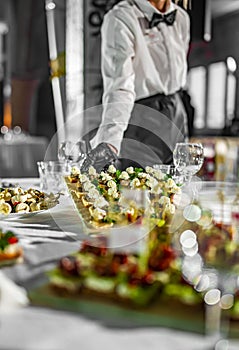 Waiter holds tray with food. Restaurant service