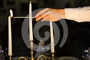 Waiter lights a candle