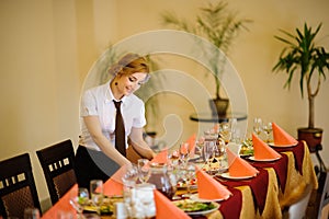 Waiter near the table with food