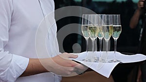 Waiter offer a glass of champagne