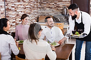 Waiter placing order in restaurant