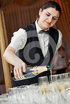 Waiter pour a glass of champagne photo