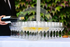 Waiter pouring champagne