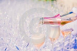 Waiter pouring champagne, sparkling wine