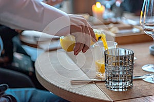 A waiter pours orange juice into a glass