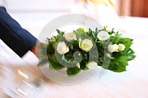 Waiter putting flowers on table
