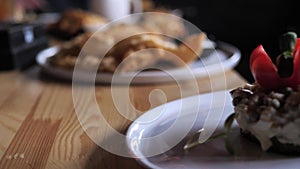 the waiter's hand puts on the table a plate with a dietary salad, proper nutrition. healthy food.