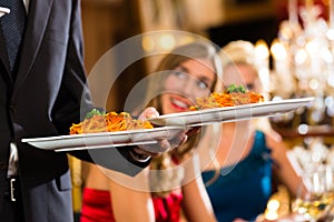 Waiter served dinner in a fine restaurant