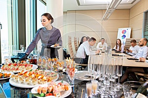 Waiter serving a banquet in the office