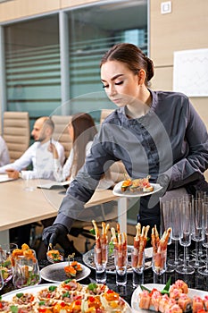 Waiter serving a banquet in the office