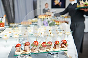 Waiter serving catering table