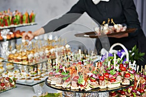 Waiter serving catering table