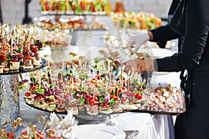 Waiter serving catering table in restaurant