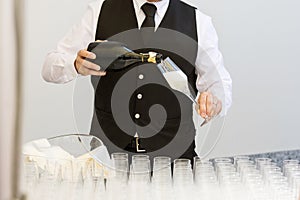 Waiter serving champagne flutes