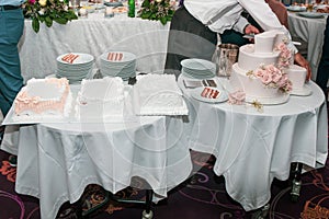 Waiter serving dessert table
