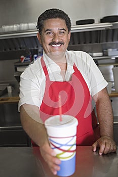 Waiter Serving Drink At Counter