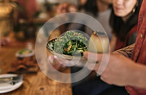 Waiter serving a healthy salad to bistro customers