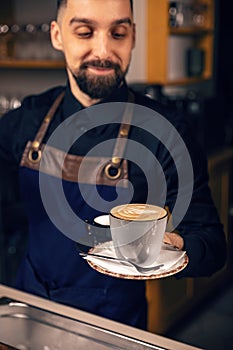 Waiter serving hot coffee