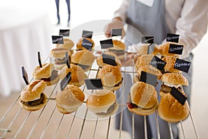 Waiter serving lamb burgers photo