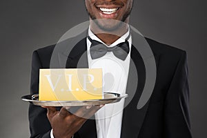 Waiter Serving Meal In Cloche photo