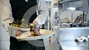 Waiter serving in motion on duty in restaurant