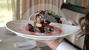 Waiter serving in motion on duty in restaurant