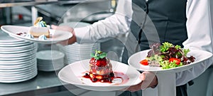 Waiter serving in motion on duty in restaurant. The waiter carries dishes