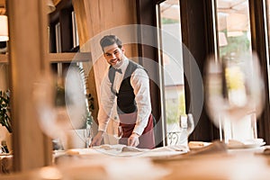 Waiter serving tables