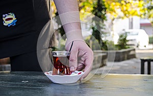 Waiter Serving Turkish Tea photo