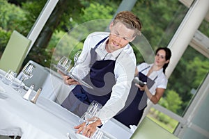 Waiter setting wedding table at restaurant