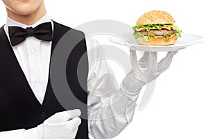 Waiter torso with hamburger on plate