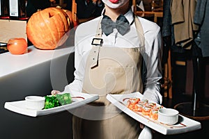 Waiters carrying plates with meat dish at a wedding