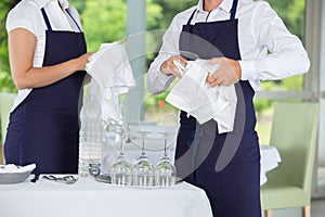Waiters cleaning glasses in restaurant photo