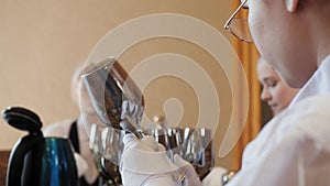 Waiters cleaning and rubbing silver glasses in restaurant