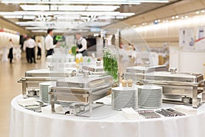 Waiters prepare buffet before a coffee break at business conference meeting.