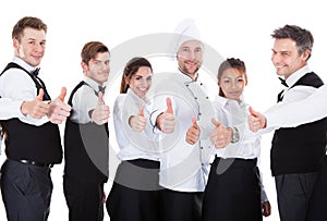 Waiters and waitresses showing thumbs up sign