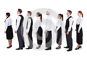 Waiters and waitresses standing in queue