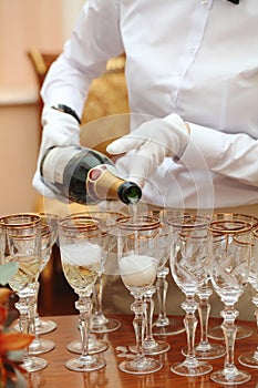Waiters in white gloves poured champagne