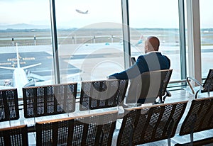 Waiting, airport and black man on a phone rest for travel, plane and air flight. Businessman, mobile connection and
