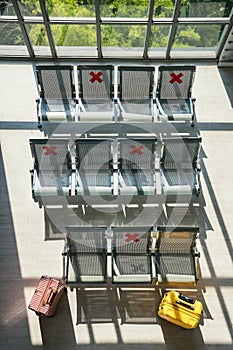 waiting chairs in airport terminal, social distancing