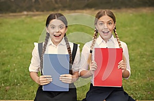 Waiting for the exam results. teen schoolgirls doing homework. Children using copybooks to study. Education and distance