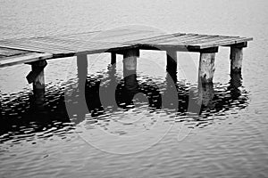 A sad wooden jetty on an autumn lake photo