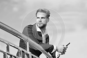 Waiting important call from partner. Businessman use smartphone for video call or texting sky background. Man in suit