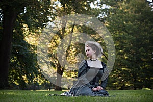 Waiting lady sitting in the grass