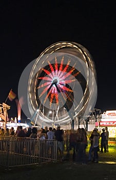 Waiting in Line with Ferris Wheel Motion Blur