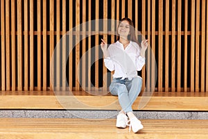 Waiting for luck. A young woman sits with crossed fingers and hopes for a miracle