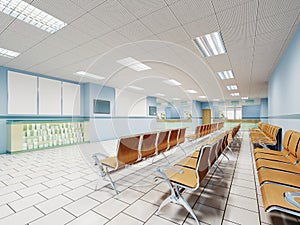 A waiting room in the clinic with orange chairs and light blue walls and white floors