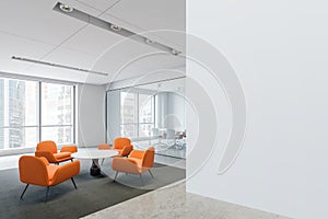 Waiting room with orange armchairs in office