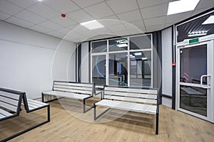 waiting room with wooden benches at a train station